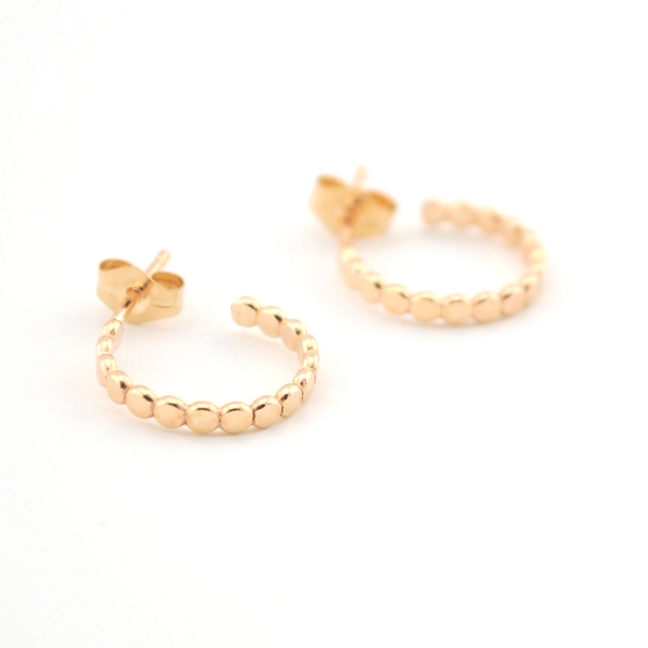 Gold hoop earrings on a white background