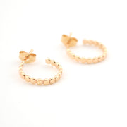 Gold hoop earrings on a white background