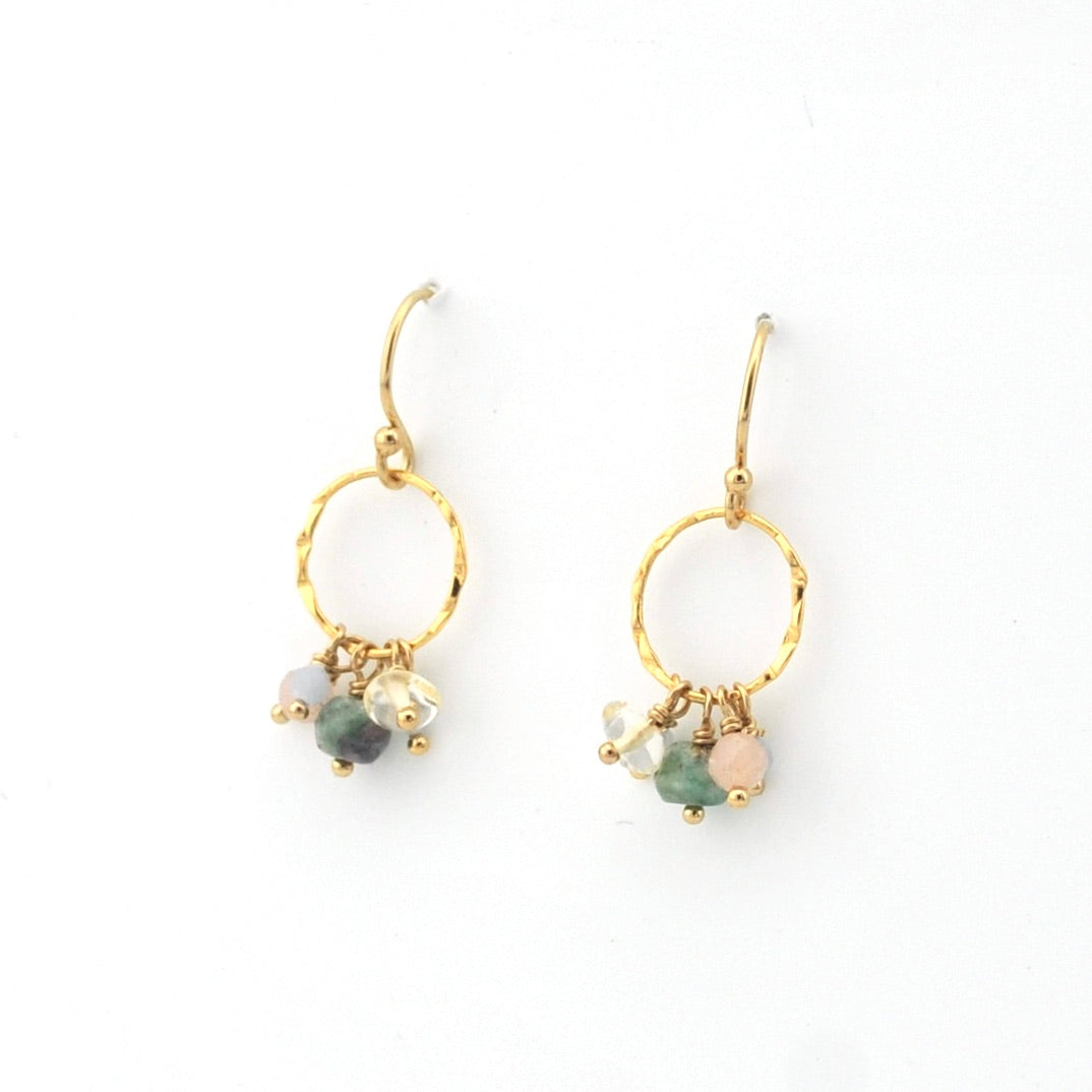 Gold hoop earrings with gemstone beads on a white background