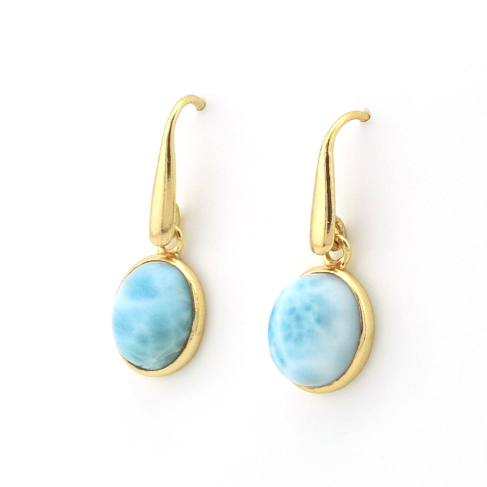 A pair of gold leverback drop earrings featuring oval light blue marbled stone cabochons, displayed on a clean white background.
