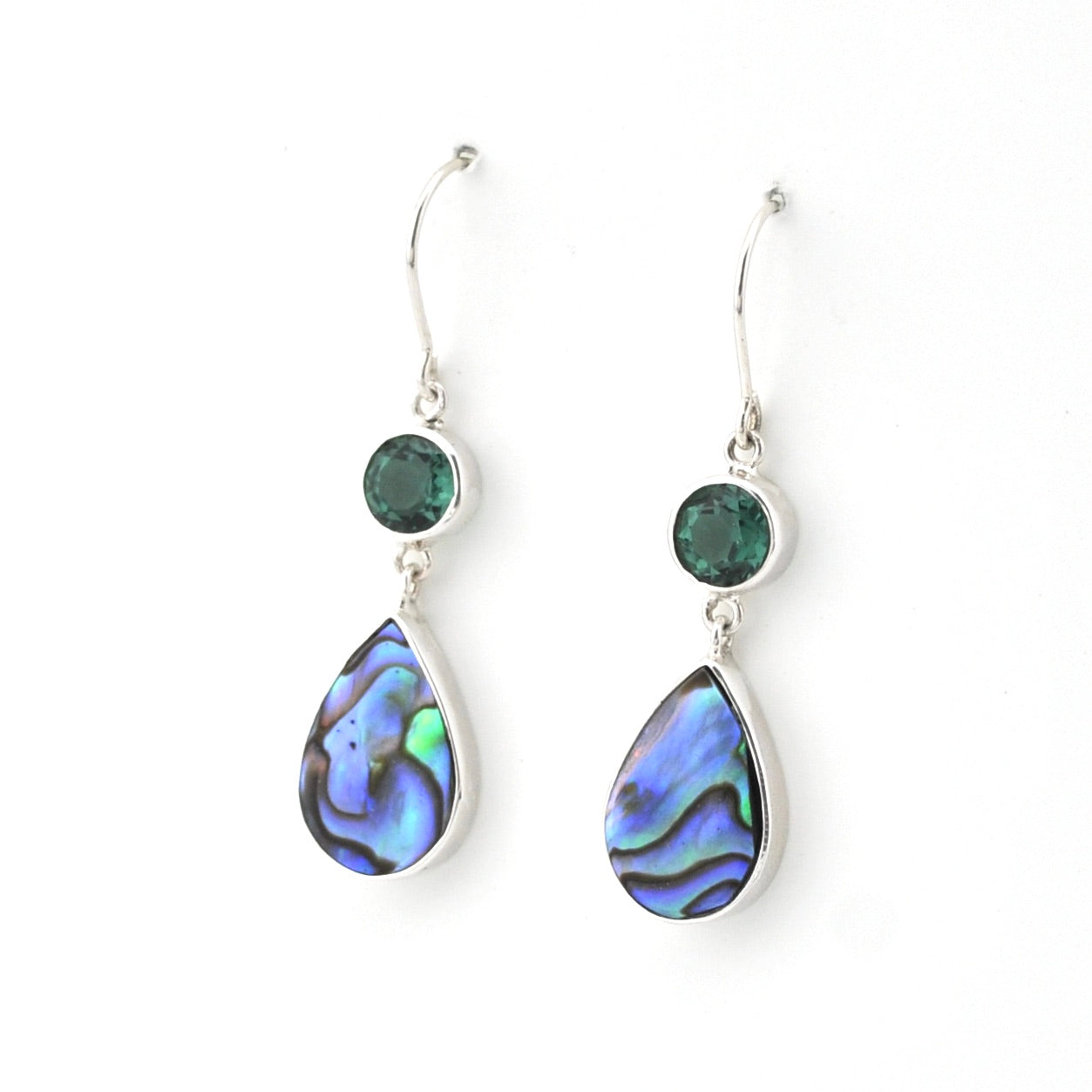 Teardrop-shaped earrings with abalone shell and green gemstones on a white background