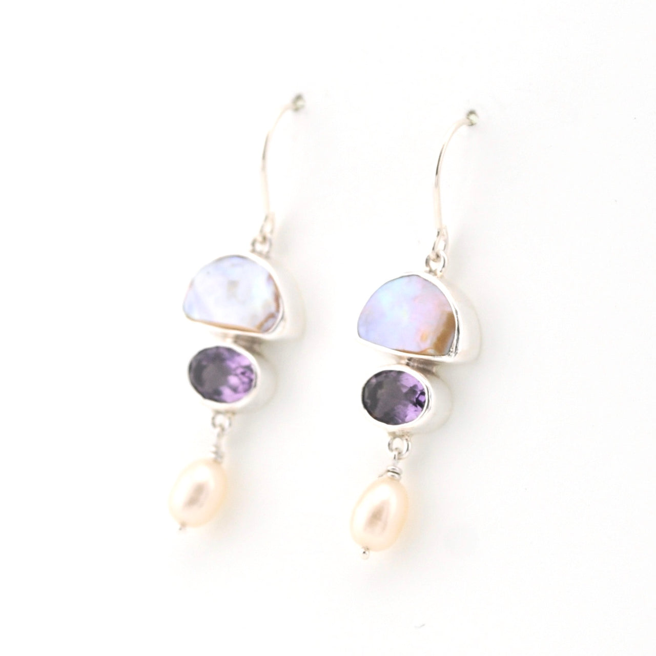 Pair of earrings with multicolored gemstones on a white background
