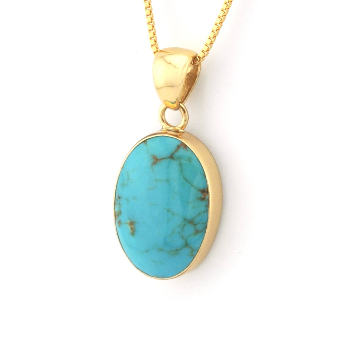 Turquoise pendant necklace with gold chain on a white background