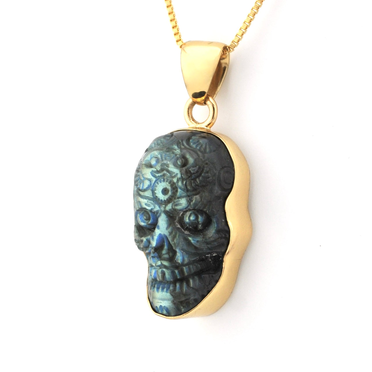 Gold pendant with a black and blue stone on a white background