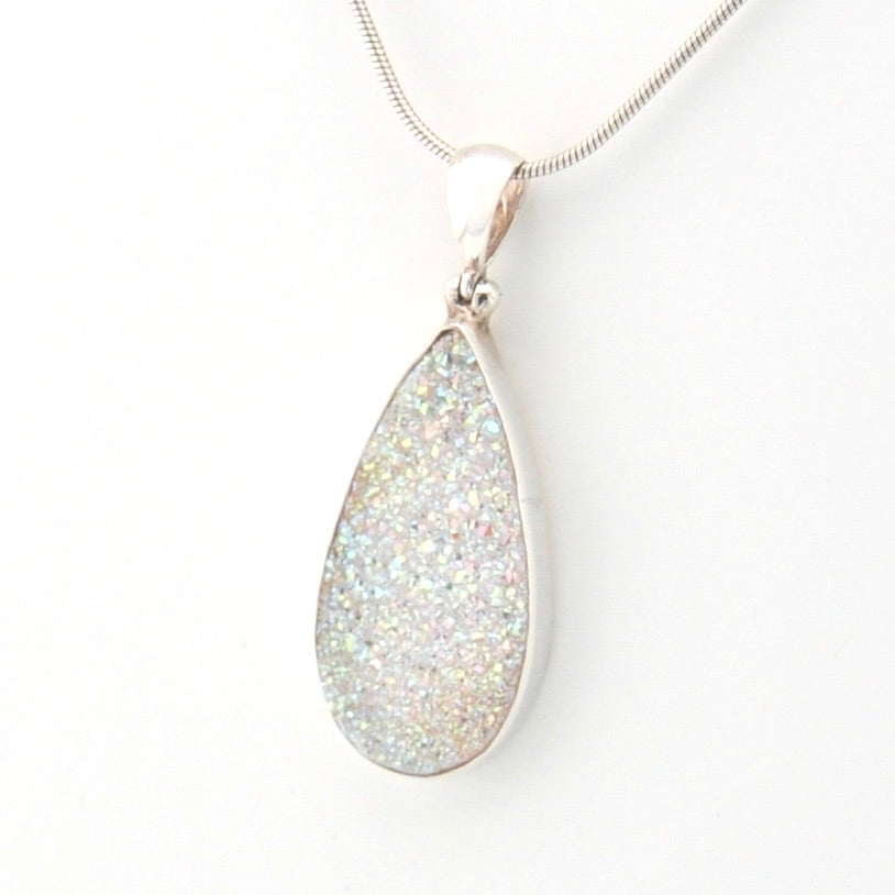 Teardrop-shaped silver pendant on a white background