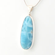 Blue larimar pendant on a white background