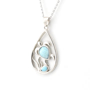 Silver teardrop pendant with a blue gemstone on a white background
