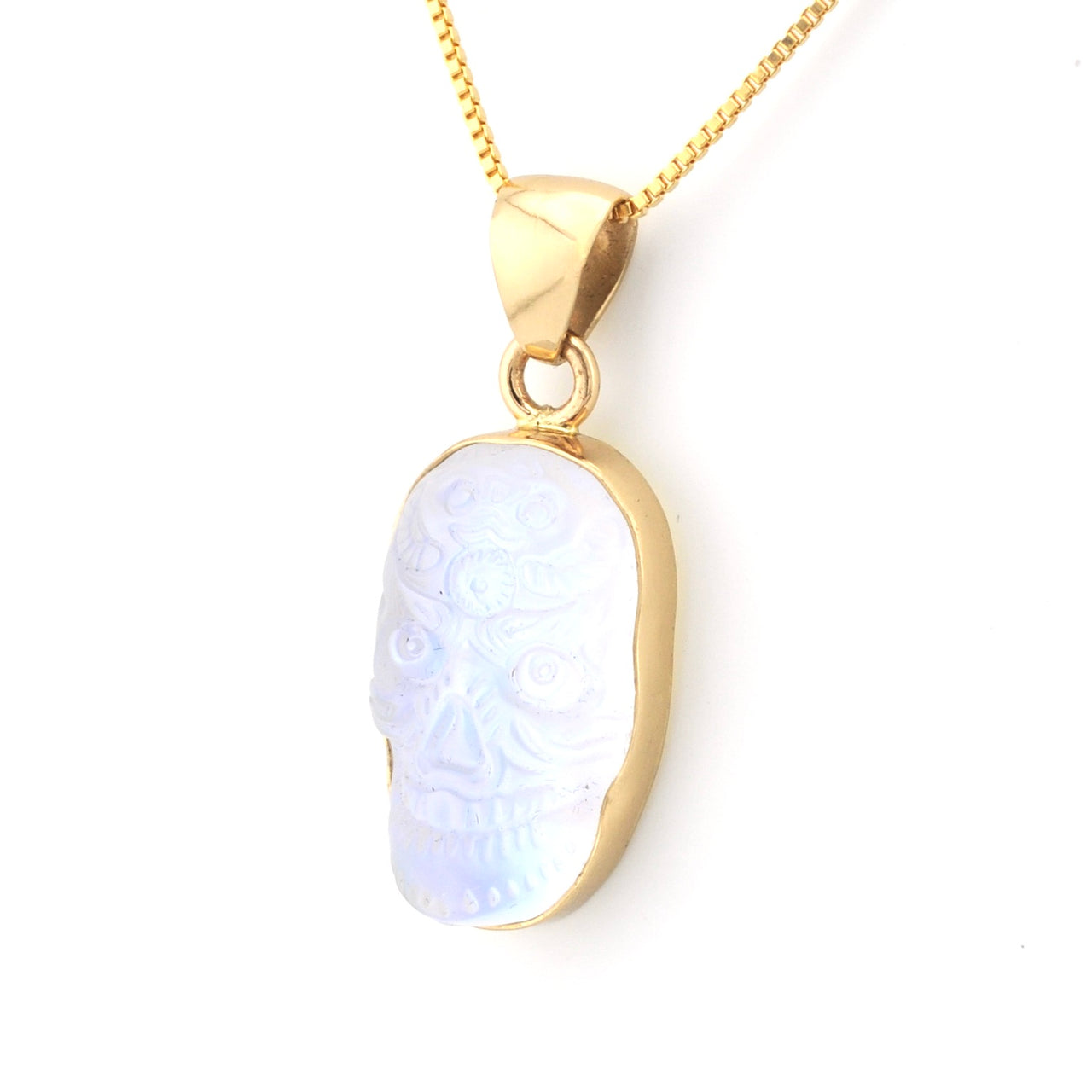Gold necklace with a pendant featuring a white stone on a white background