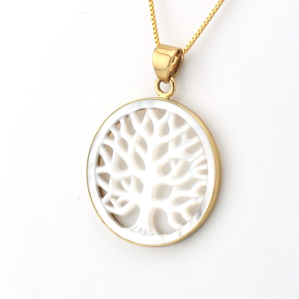 White tree pendant with gold chain on a white background