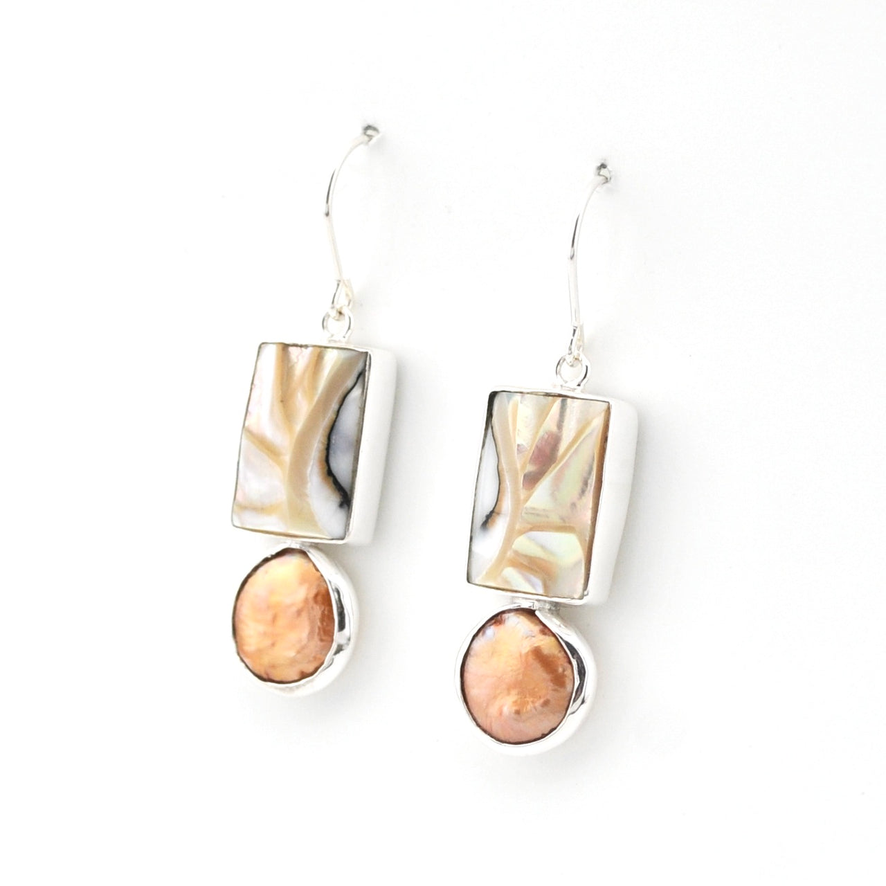 Pair of earrings with marbled stone drops on a white background