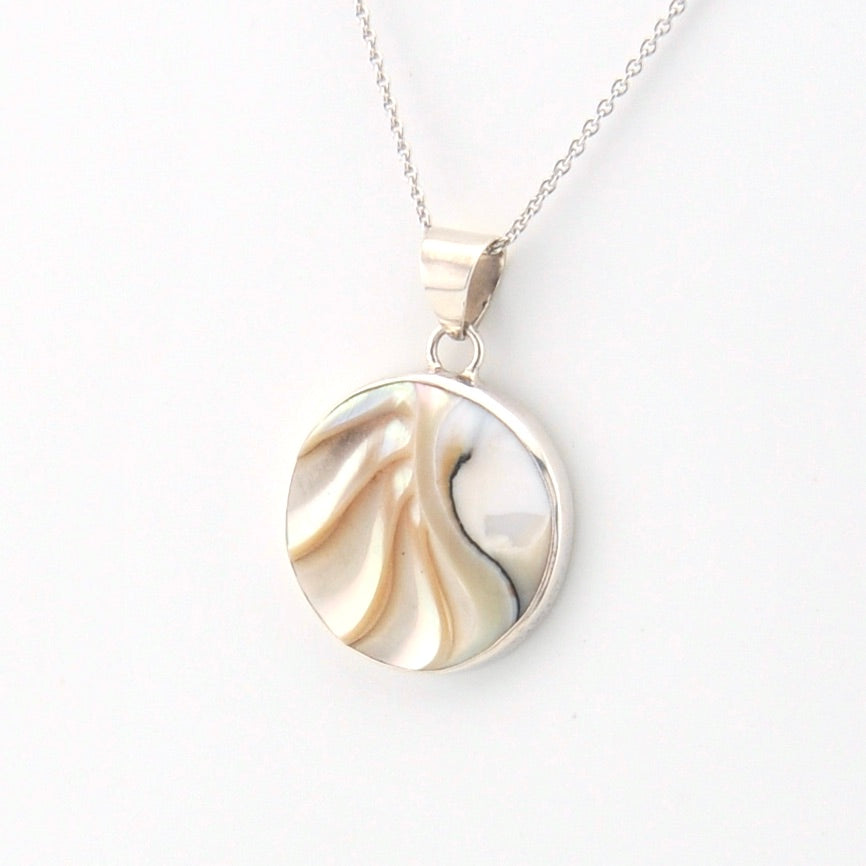 Round pendant with shell on a white background