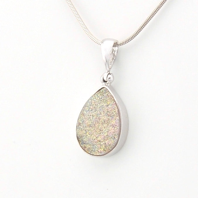 Teardrop-shaped pendant on a chain against a white background