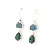 Pair of earrings with green teardrop-shaped stones on a white background