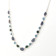 Necklace with blue and green gemstones on a white background