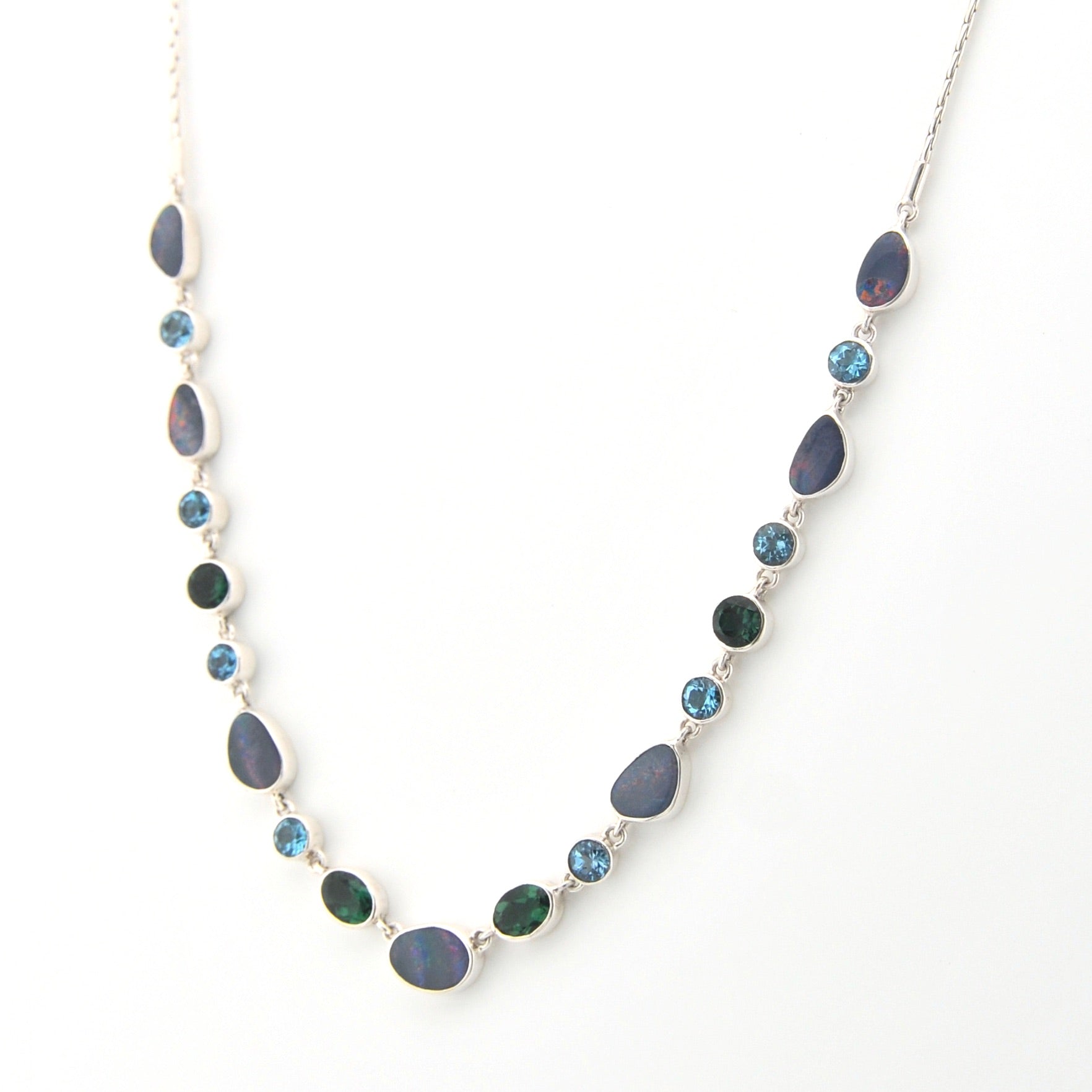 Necklace with blue and green gemstones on a white background
