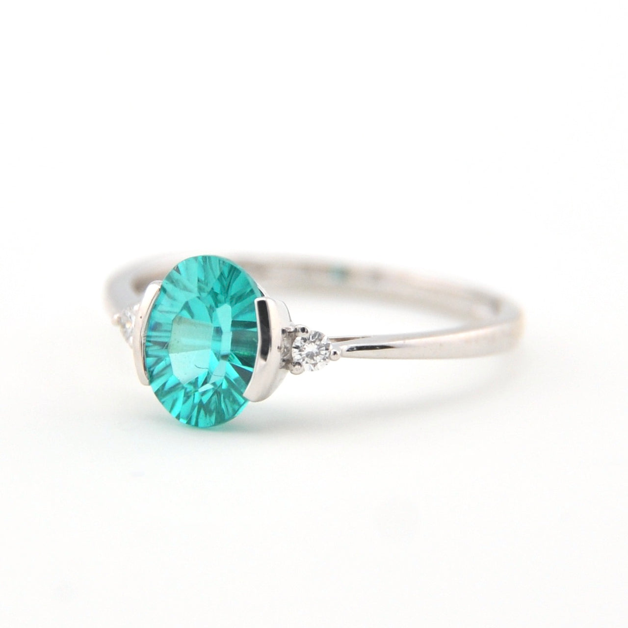 Silver ring with a turquoise gemstone on a white background