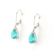 Pair of earrings with teal teardrop stones on a white background