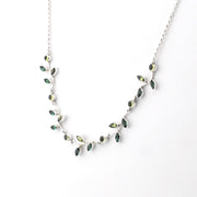 Necklace with green gemstones on a white background