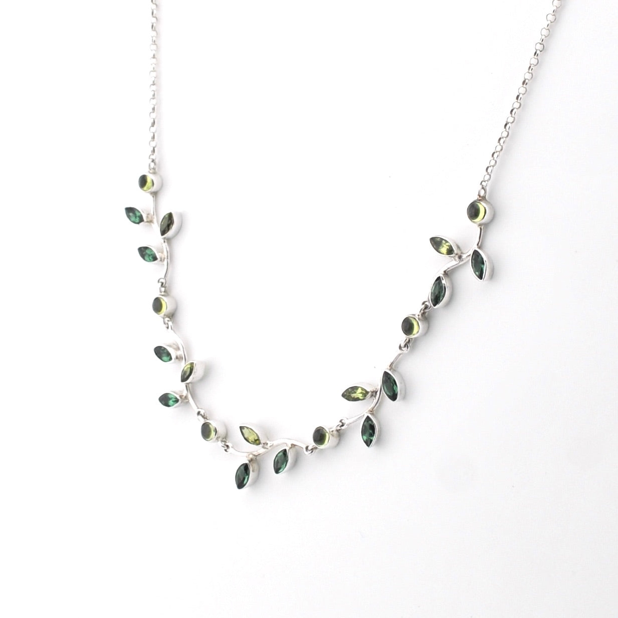Necklace with green gemstones on a white background