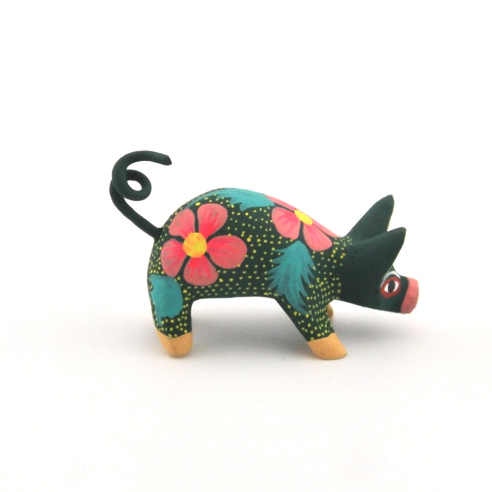 Colorful pig figurine with floral patterns on a white background
