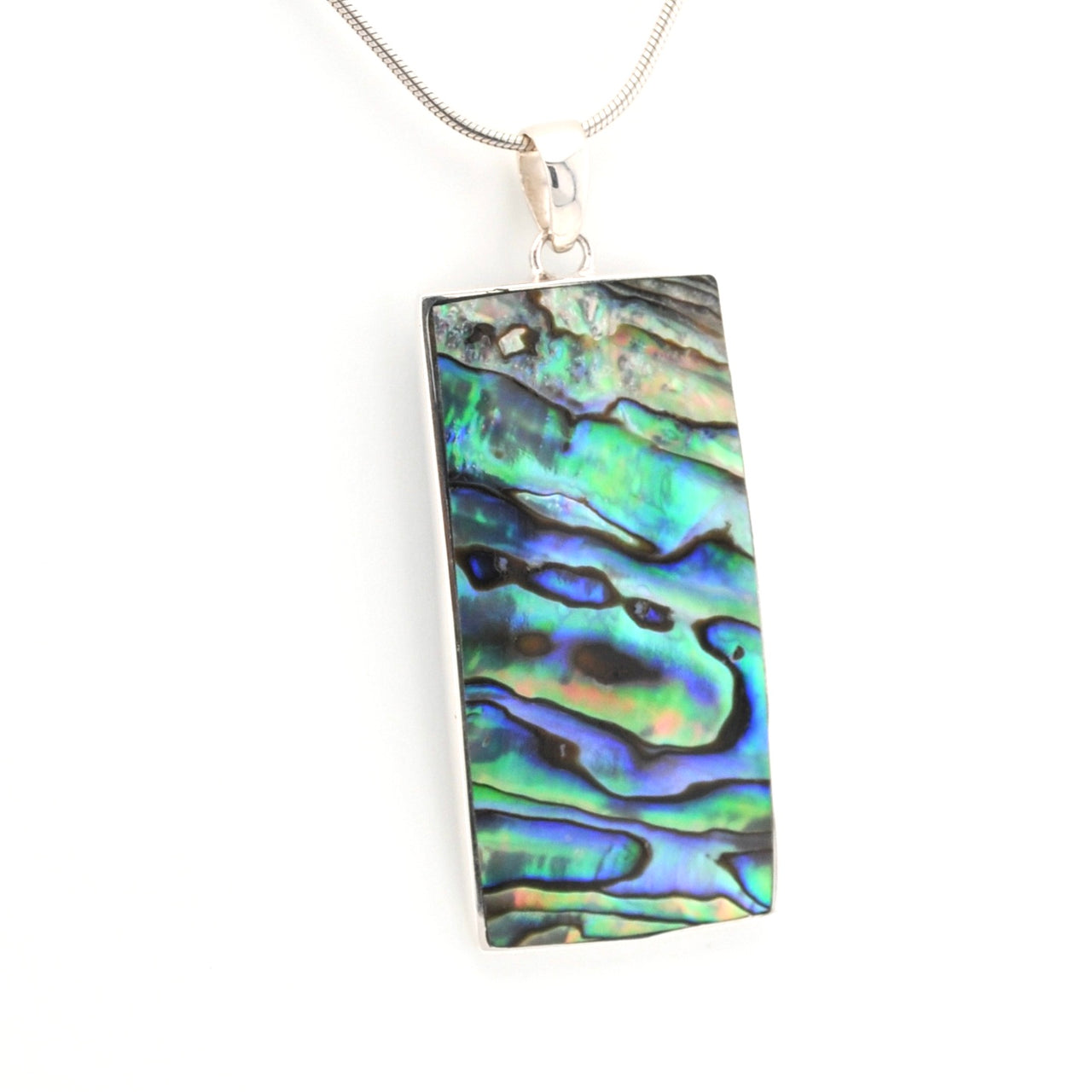 Multicolored abalone shell pendant on a white background