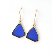 Blue teardrop earrings with gold hooks on a white background