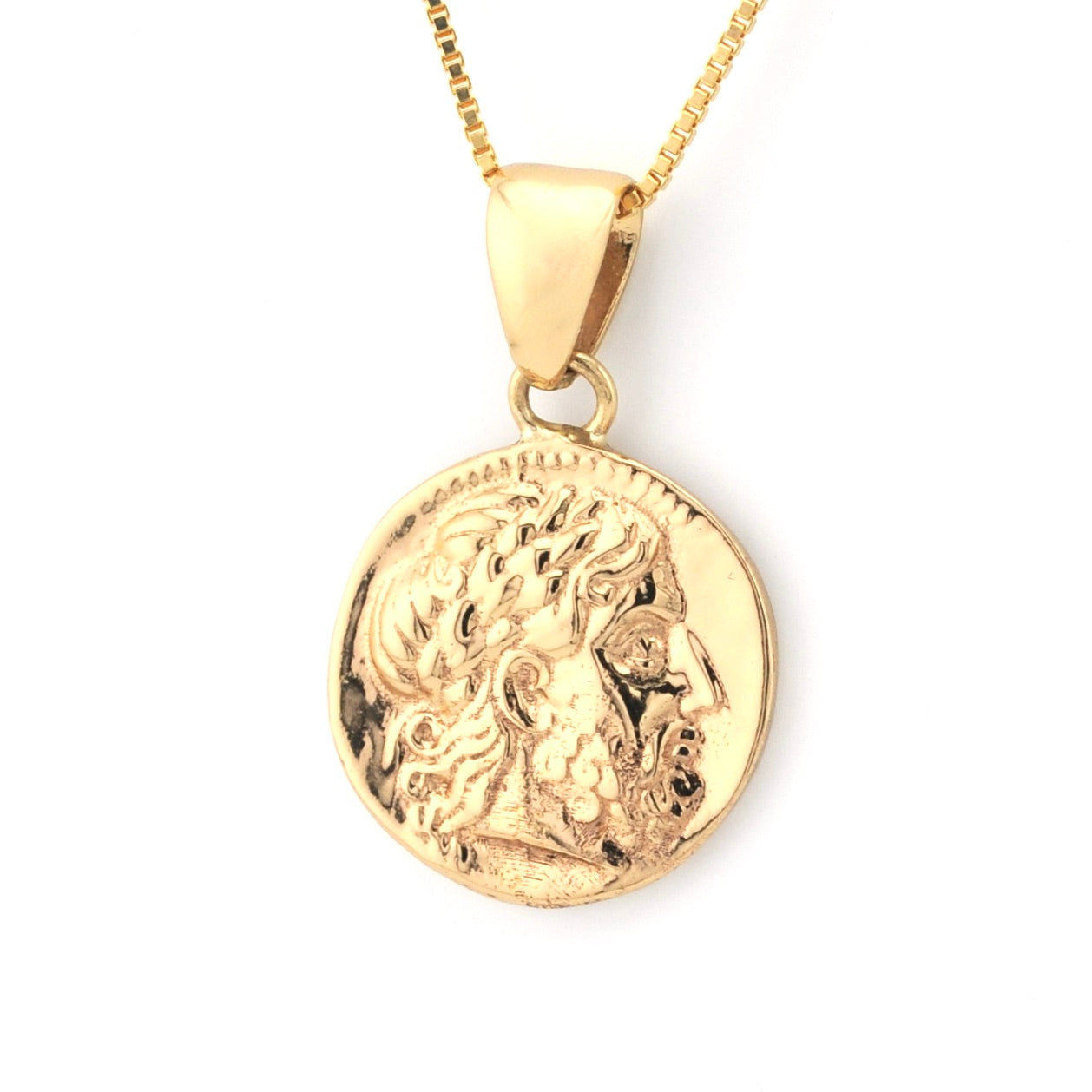 Gold pendant necklace with a detailed design on a white background