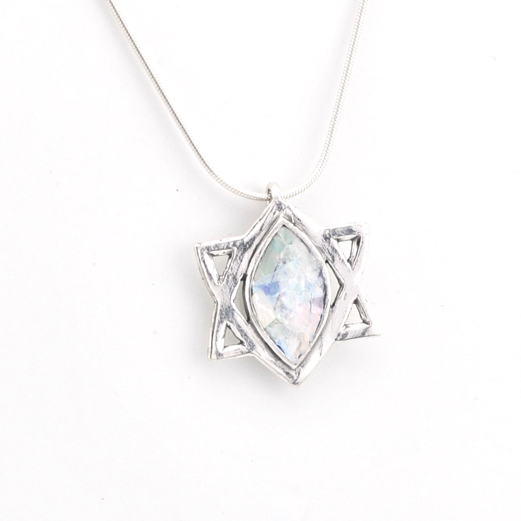 Silver pendant with Roman glass on a white background