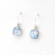 Pair of silver hoop earrings with light blue glass on a white background