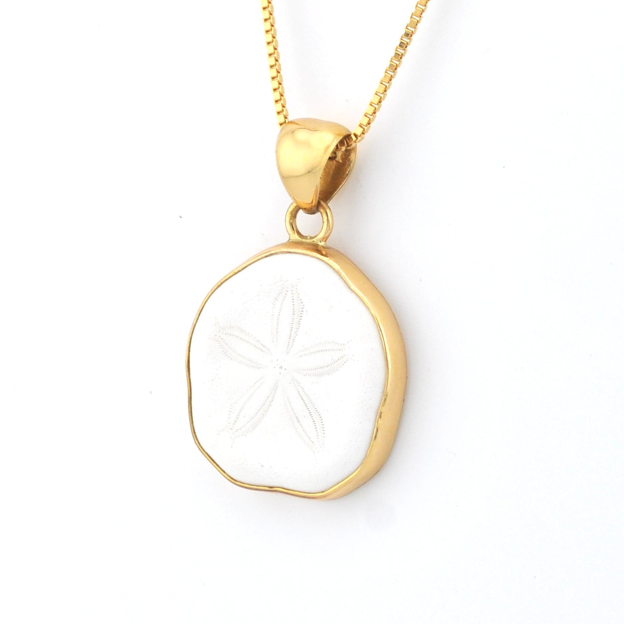 Gold necklace with a white circular pendant on a white background