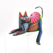 Colorful cat-shaped decorative item with floral patterns on a white background