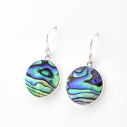 Abalone shell earrings on silver hooks against a white background