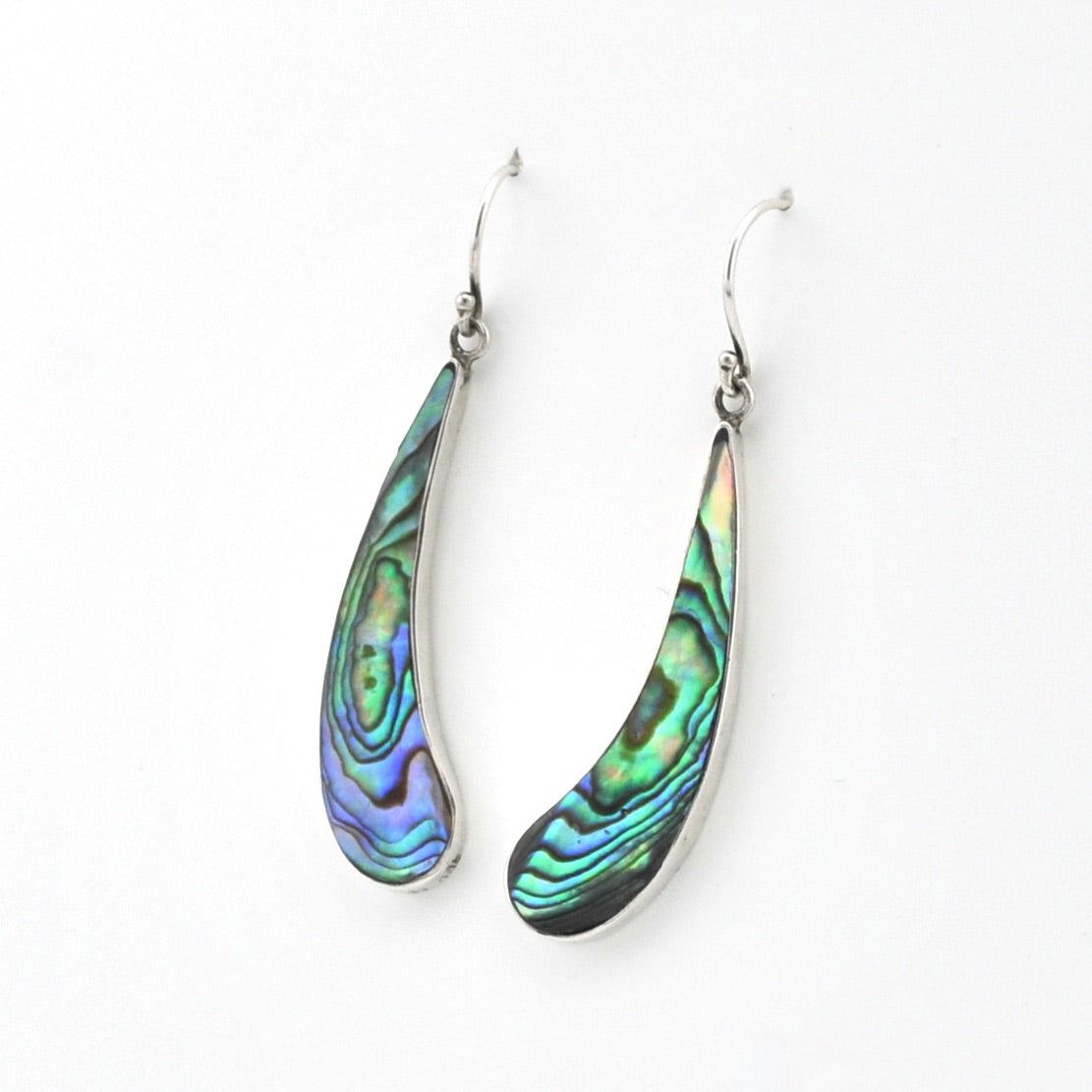 Teardrop-shaped abalone shell earrings on a white background