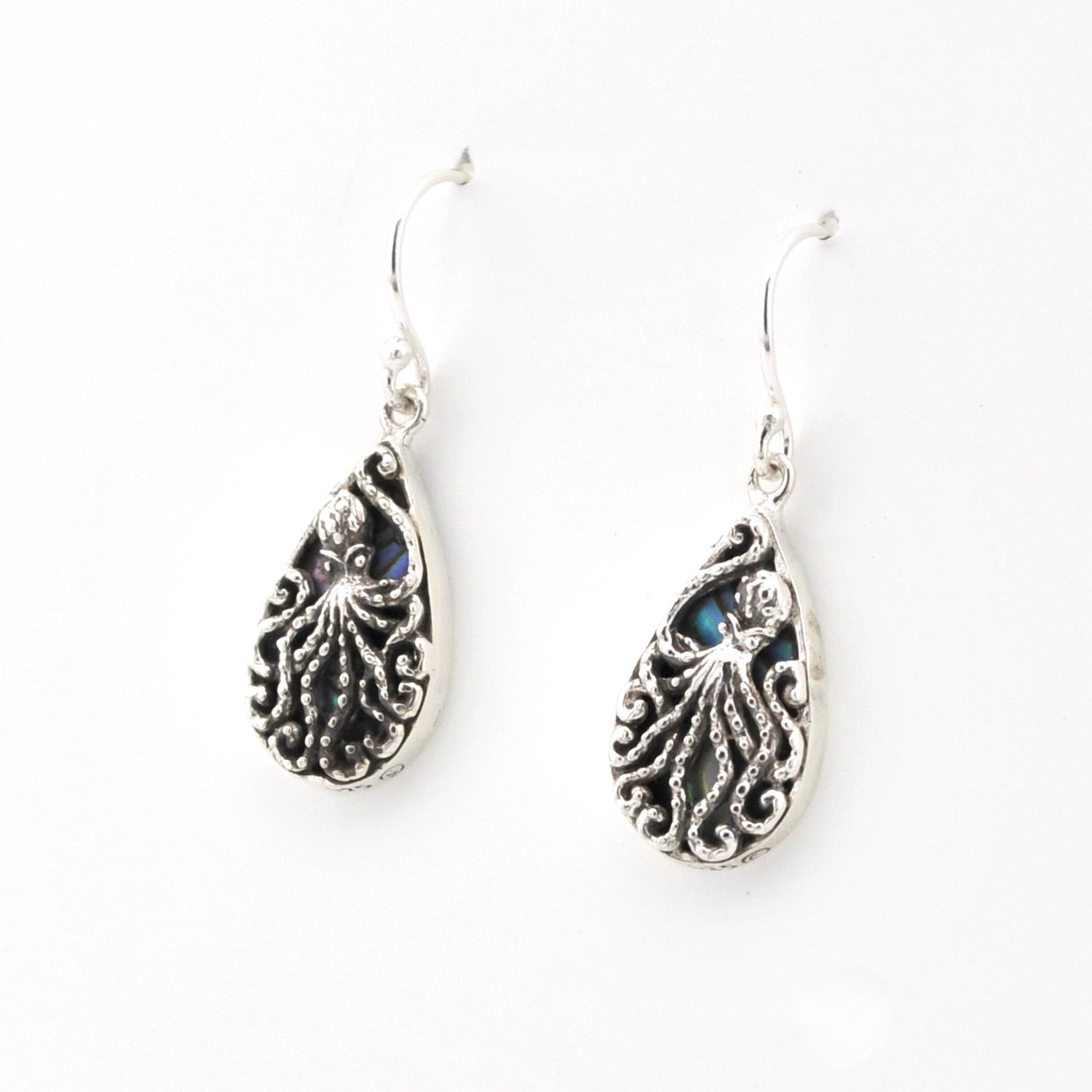 Silver octopus earrings with blue gemstones on a white background