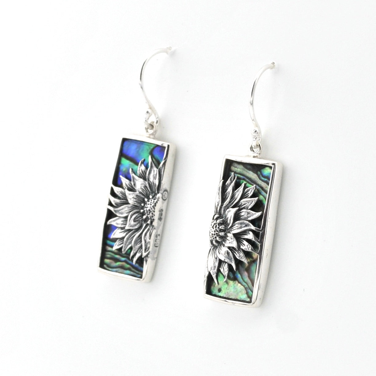 Pair of earrings with floral design on a white background
