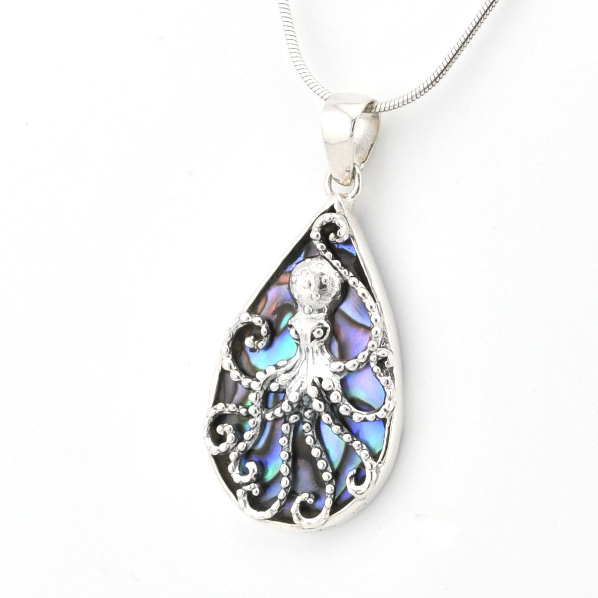 Teardrop-shaped pendant with intricate design on a white background