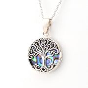Silver tree of life pendant with abalone shell inlay on a white background