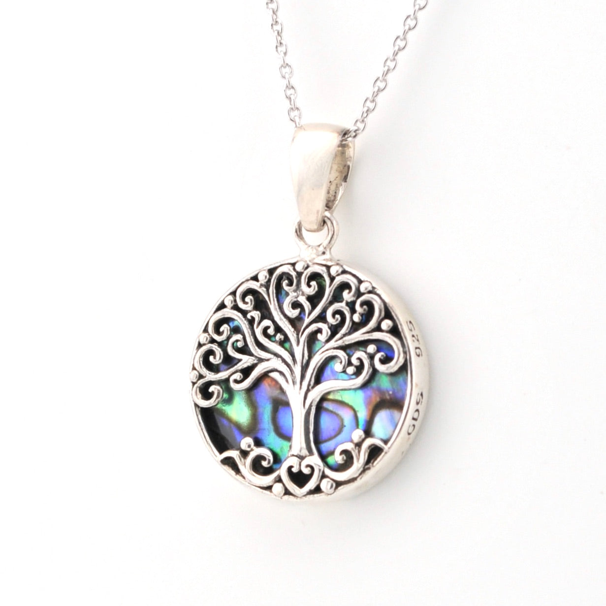 Silver tree of life pendant with abalone shell inlay on a white background