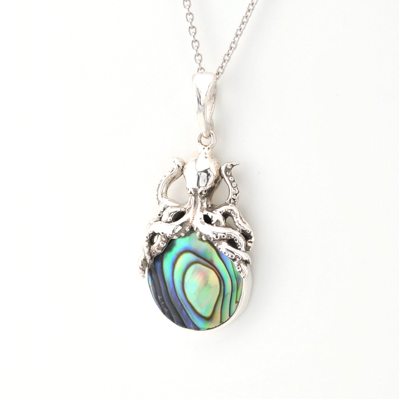 Silver pendant with abalone shell on a white background