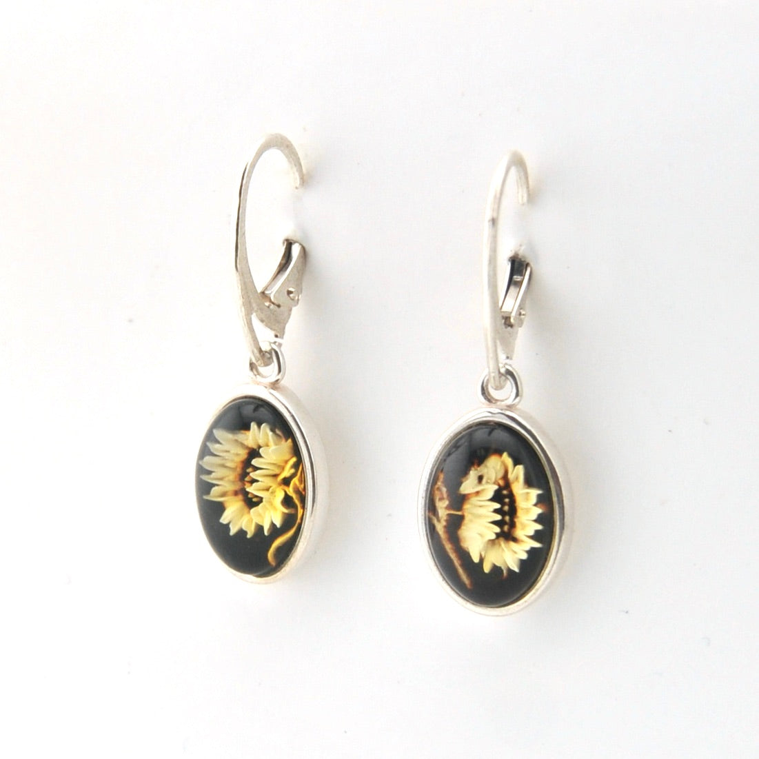 Pair of earrings with sunflower design on a white background