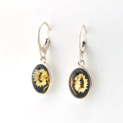 Pair of earrings with sunflower design on a white background