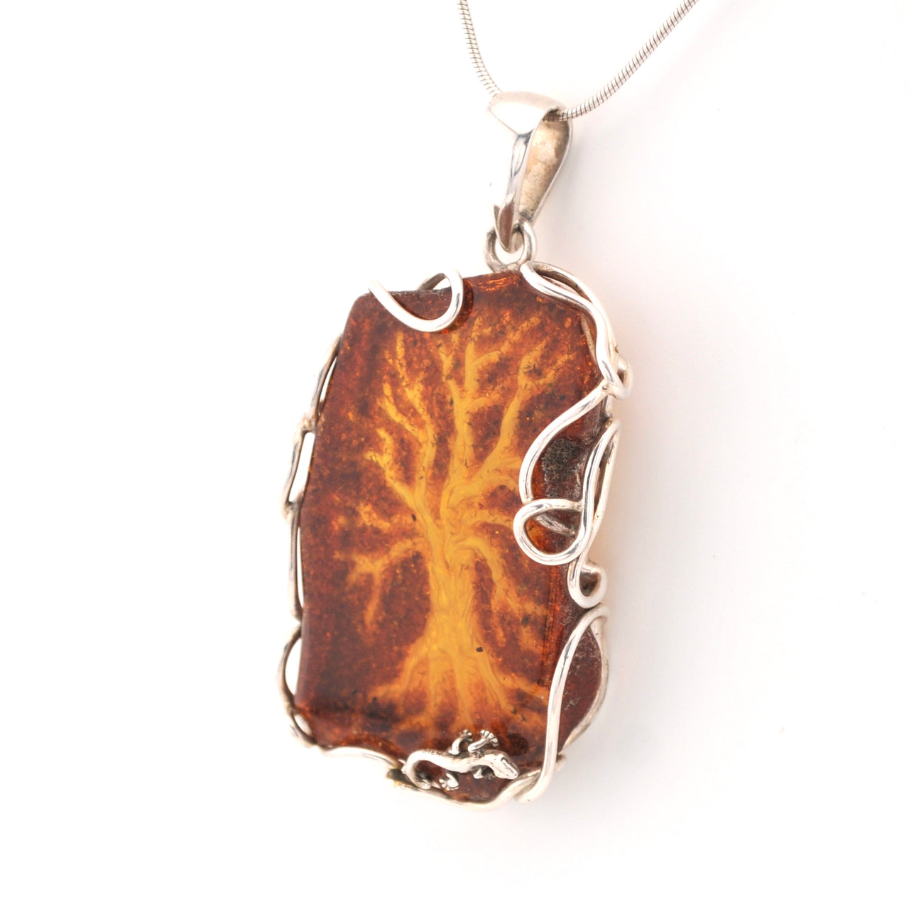 Pendant with brown stone and silver frame on a white background