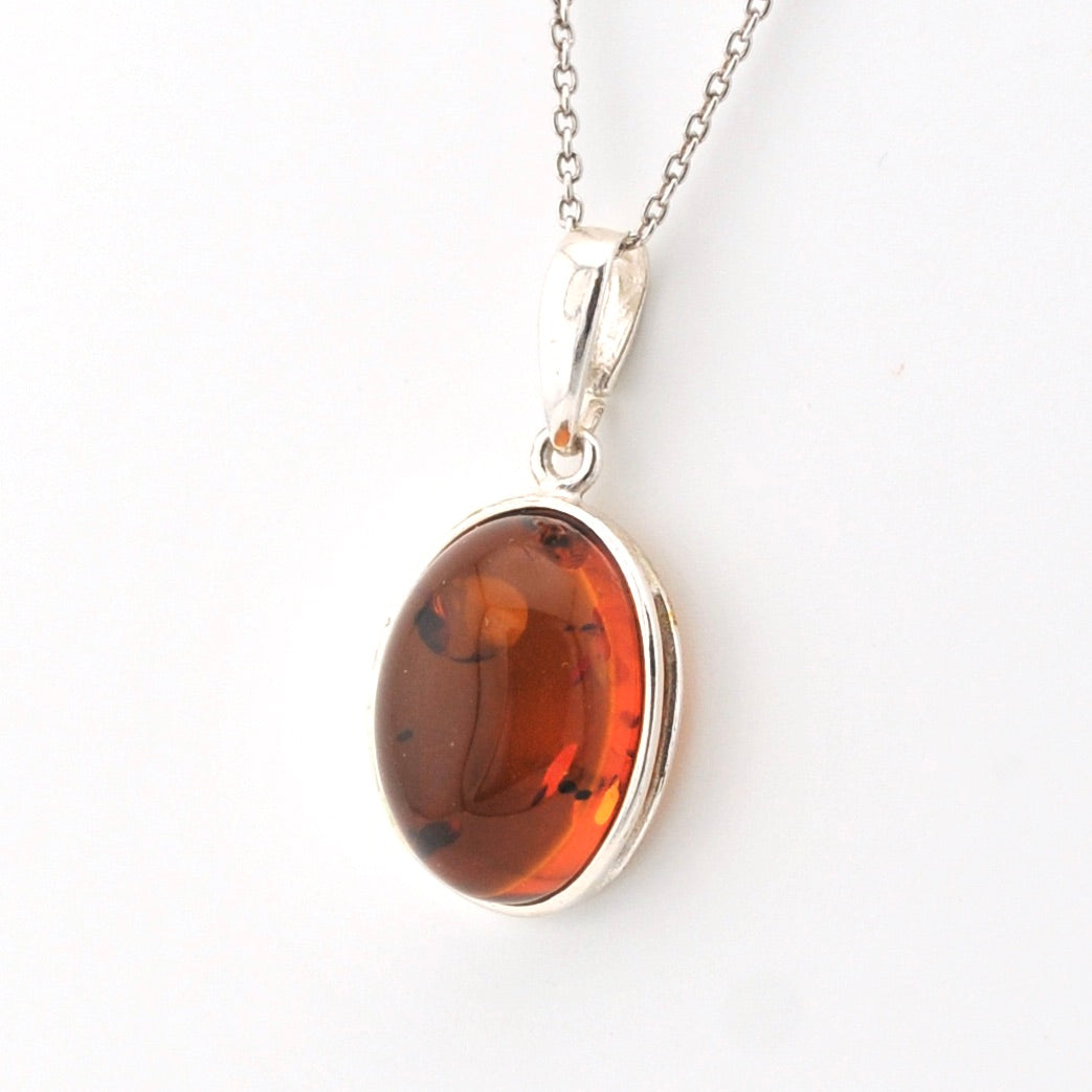 Amber pendant necklace on a white background