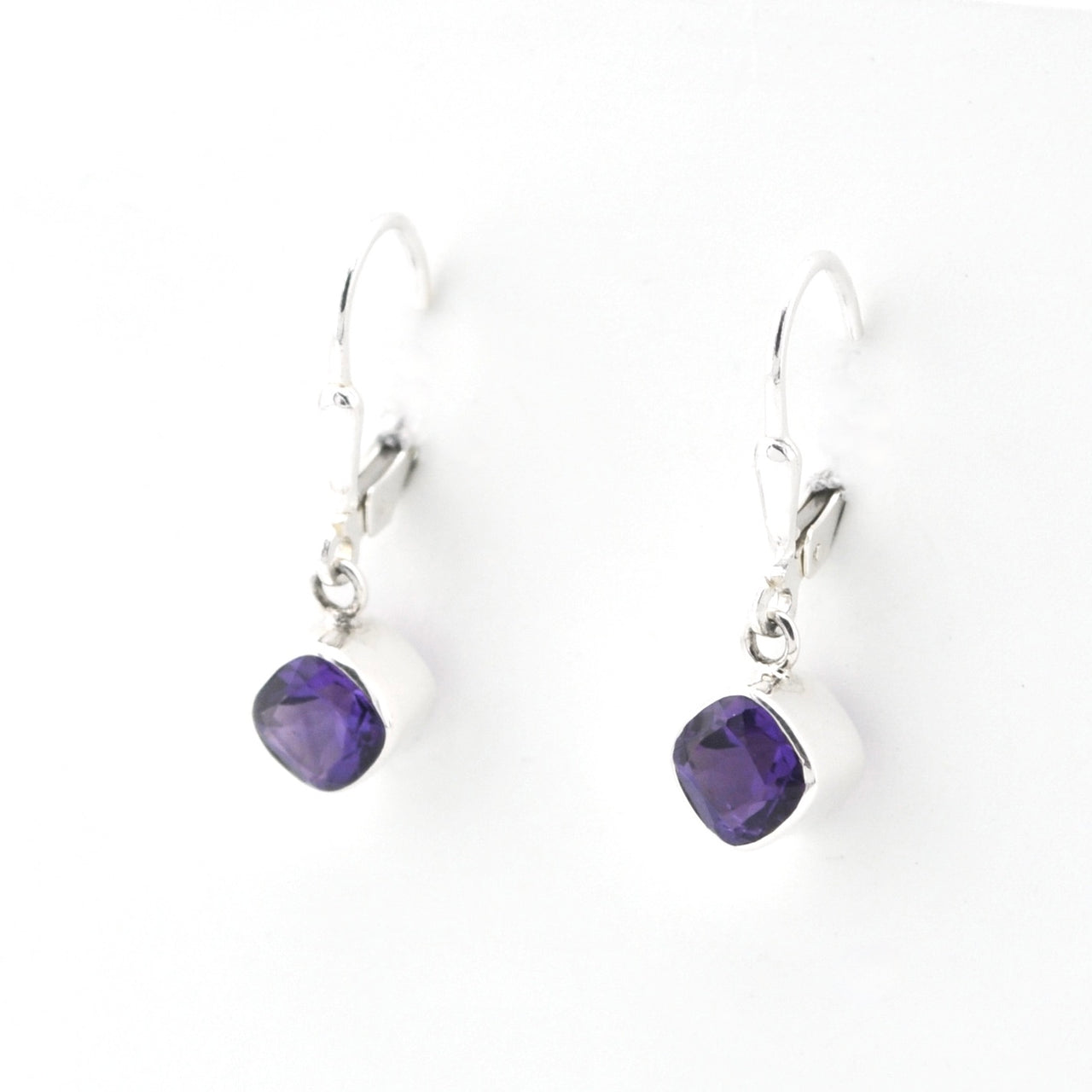 Pair of purple teardrop earrings on a white background