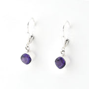 Pair of purple teardrop earrings on a white background