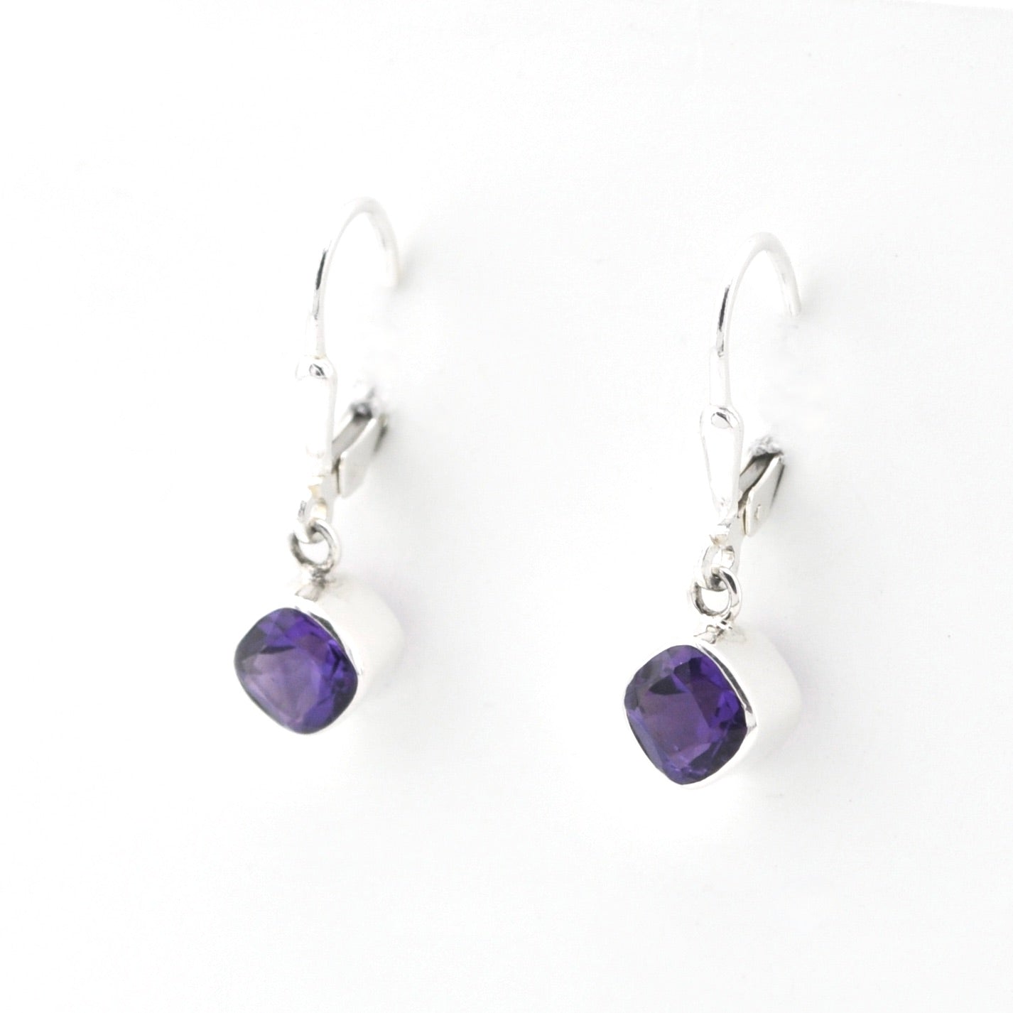 Pair of purple teardrop earrings on a white background