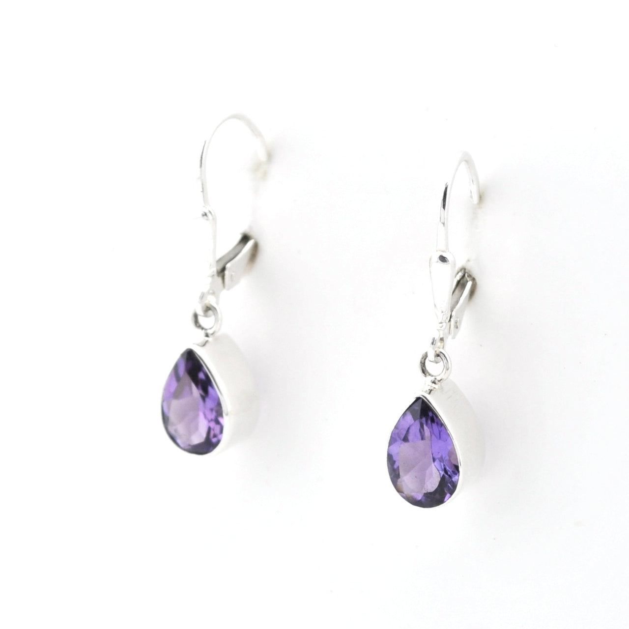 Pair of silver earrings with purple teardrop-shaped gemstones on a white background