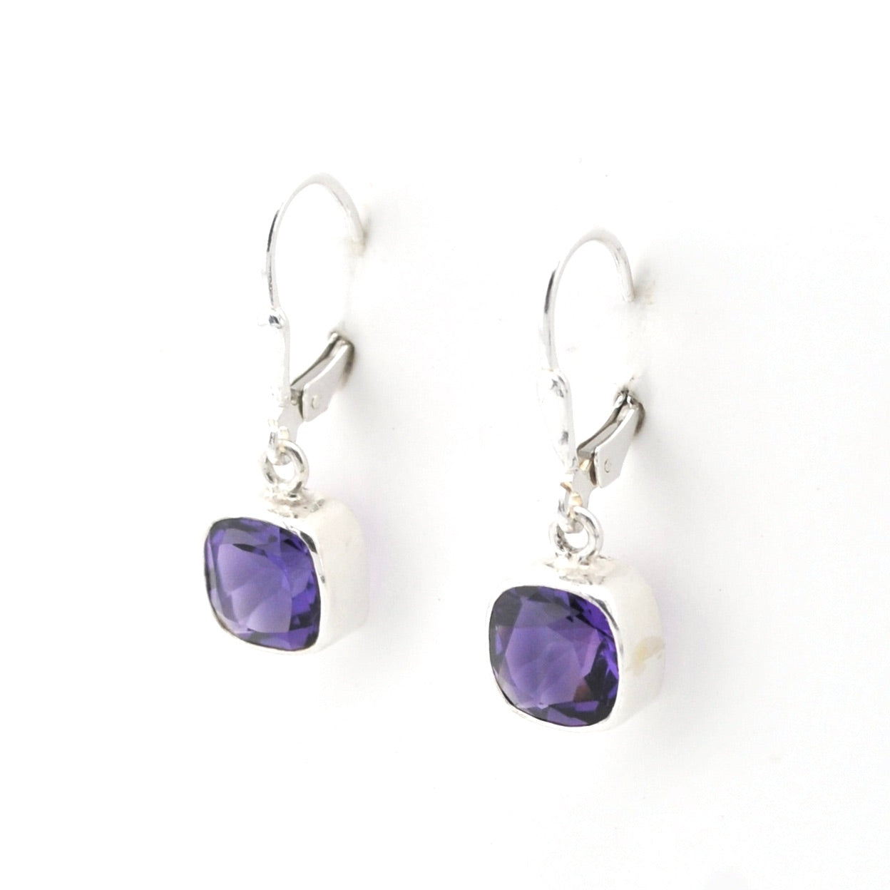 Pair of purple gemstone earrings on a white background