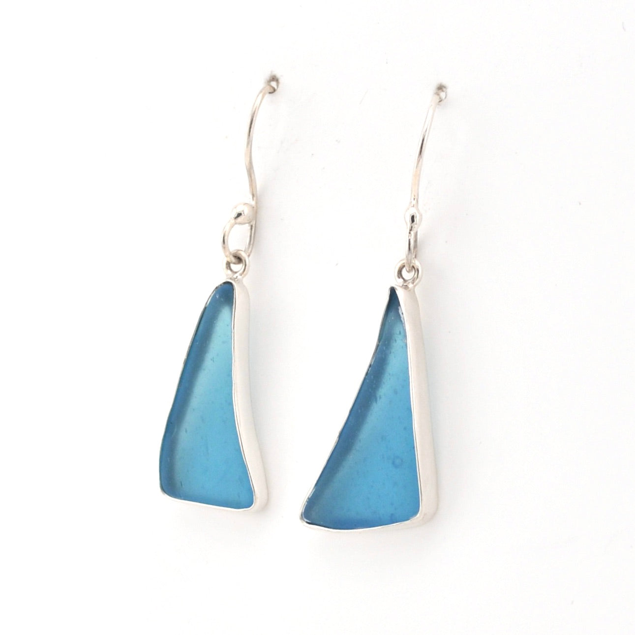 Blue triangular earrings on a white background