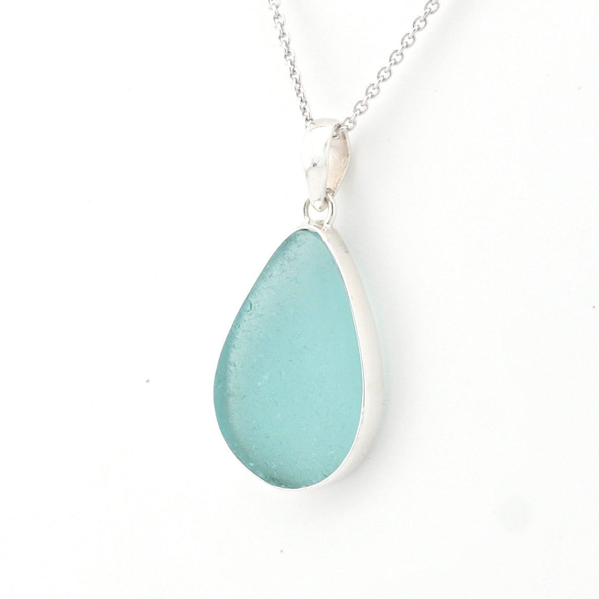 Teardrop-shaped blue pendant on a white background